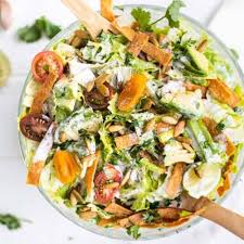 Mexican Caesar Salad with crisp romaine, roasted corn, tortilla strips, and creamy lime dressing.